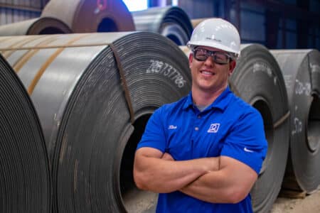 homepage blue shirt guy in front of pipe