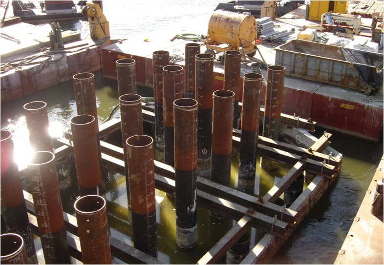 products piling redish pipe partly submerged