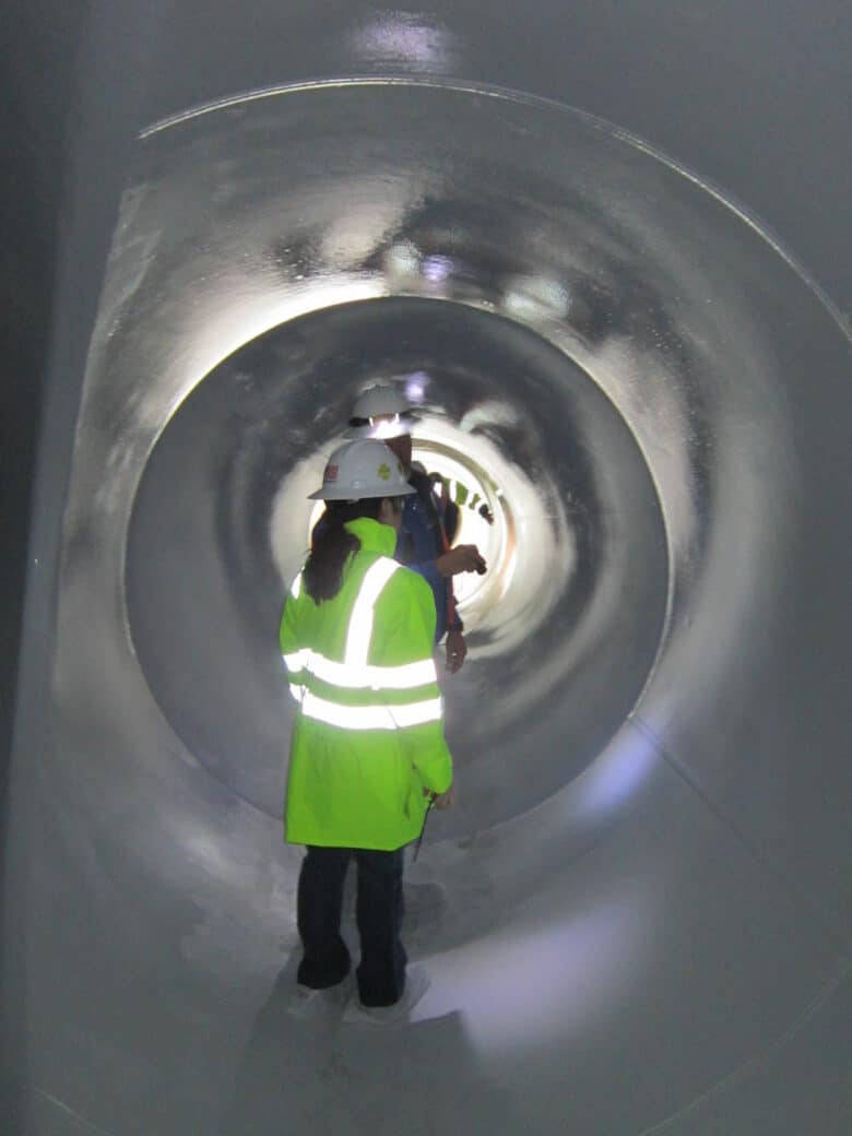 workers inside epoxy lined pipe