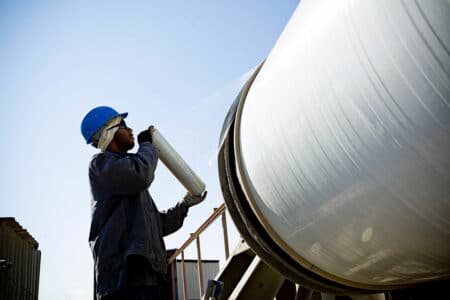 guy holding pipe in front of pipe