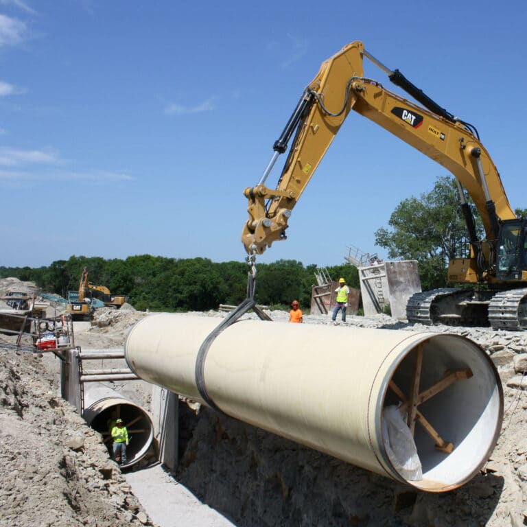 hompage crane lifting large grey pipe cropped