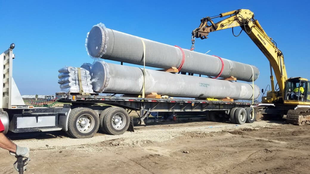 product esp stacked pipes on truck with crane