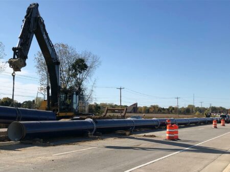 racine water transmission crane with long pipe in road