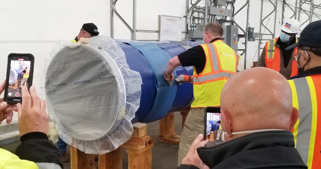 Applying heat shrink sleeve to poly coated 36-inch pipe section demonstration