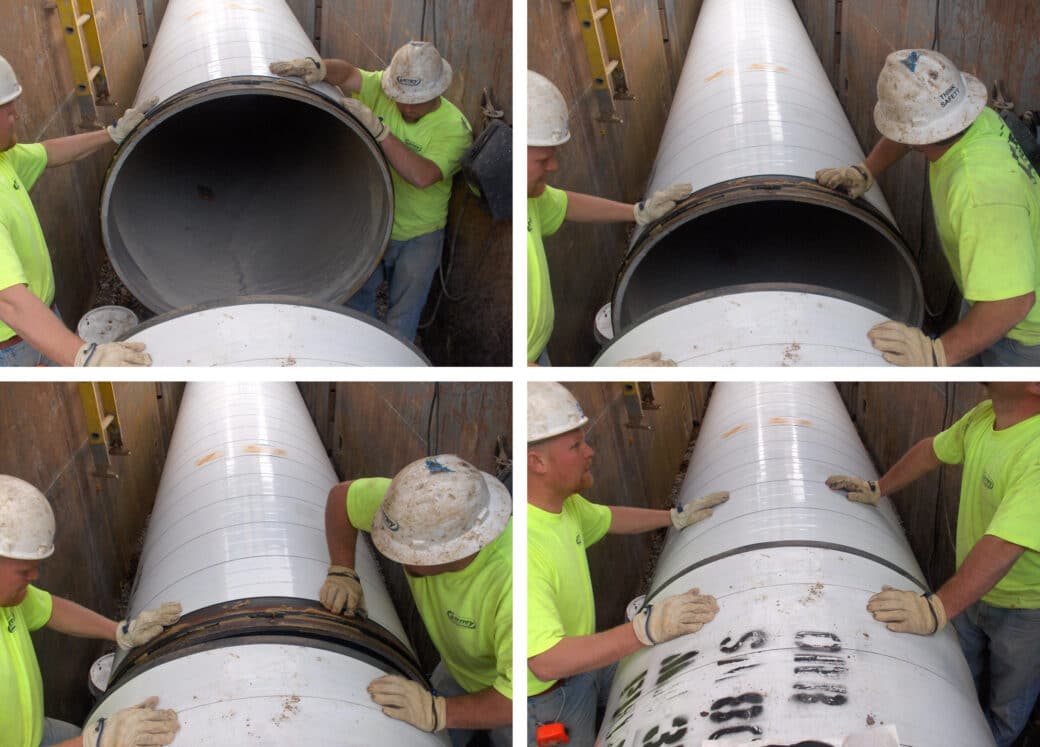 Two workers in hardhats connecting pipe with O-Ring Joint