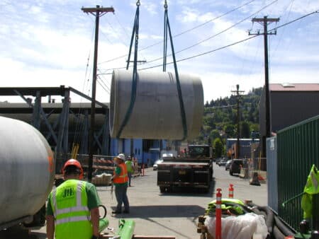 Concrete jacking pipe being lifted by crane for installation