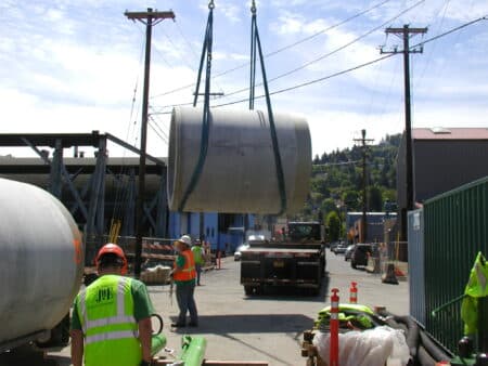 Concrete jacking pipe being lifted by crane for installation