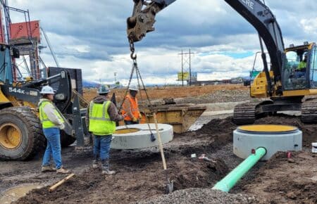 Construction crew and crane installing Perfect Lined Manhole