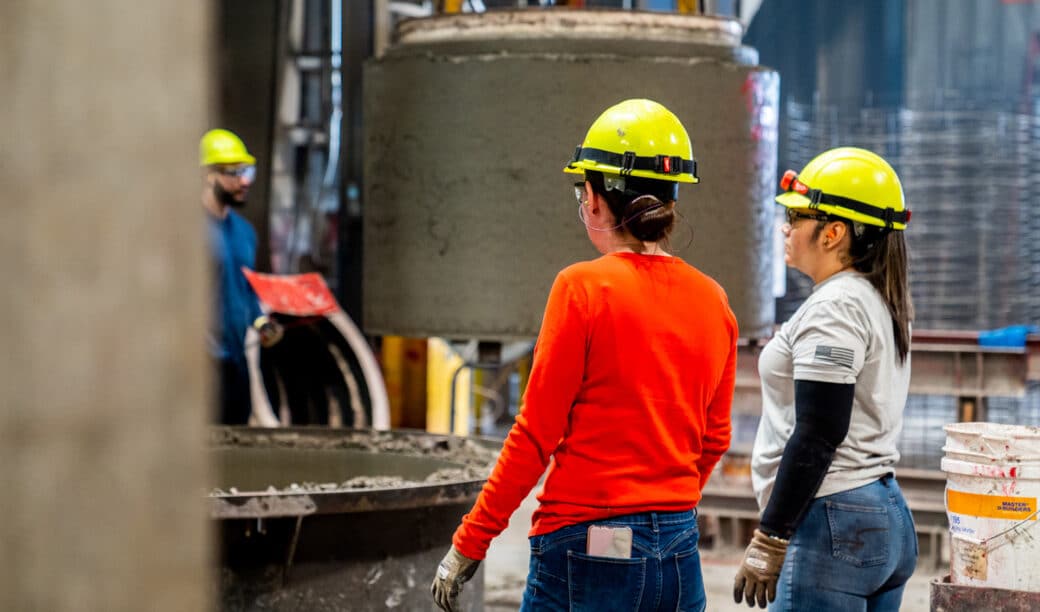 Two workers in safety helmets