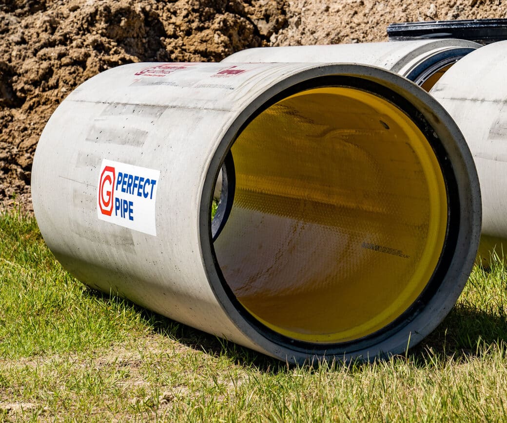 concrete jacking pipe with yellow liner on grass