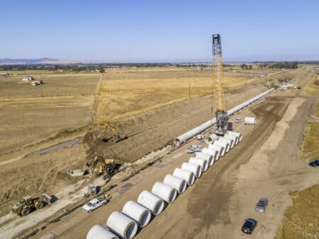 Installing large diameter concrete pipe in a trench using a crane