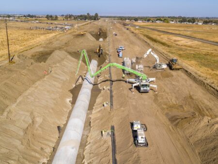 Installing large diameter concrete pipe in a trench using a crane