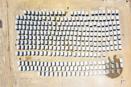 Aerial view of rows of concrete pipe on the ground