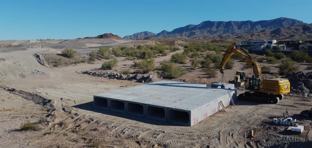 Concrete box culvert being installed in desert landscape