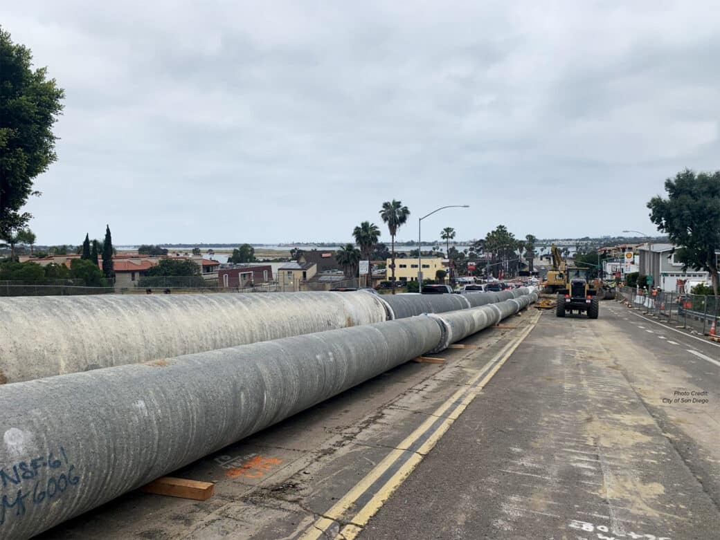 Large diameter cement mortar coated steel pipe on a road awaiting install